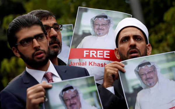FILE PHOTO: Human rights activists and friends of Saudi journalist Khashoggi hold his pictures during a protest outside the Saudi Consulate in Istanbul