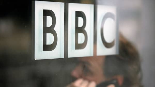FILE PHOTO: A man talks on a mobile phone inside the BBC headquarters in London