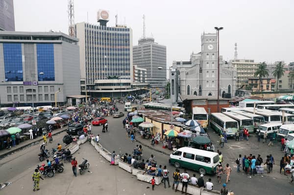 People move on a street of Marina in Victoria Island