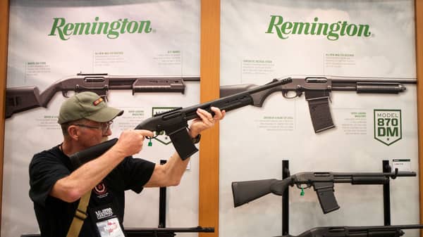 A man aims a Remington firearm at the annual NRA meeting in Dallas, Texas