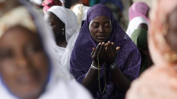 A Muslim woman prays in a mosque, marking the end of the Muslim holy month of Ramadan, in Lagos