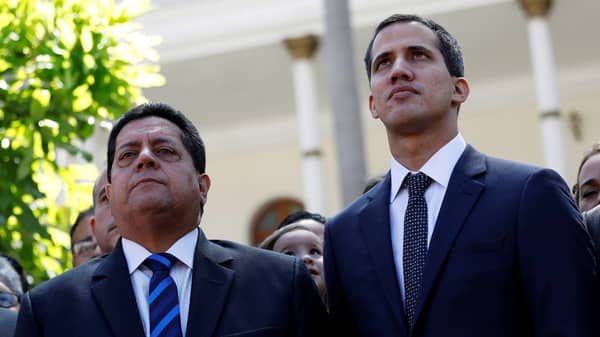 FILE PHOTO: Juan Guaido, new President of the National Constituent Assembly and lawmaker of the Venezuelan opposition party Popular Will, and lawmaker Edgar Zambrano of Democratic Action party, leave the congress in Caracas