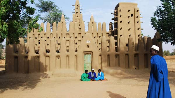Muslim Dogons talk in front of a mud mosque in the village of Koni Komboro