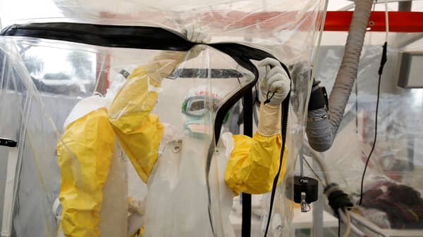 A health worker wearing Ebola protection gear enters the Biosecure Emergency Care Unit at the ALIMA Ebola treatment centre in Beni