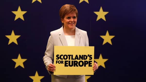 Scotland’s First Minister Nicola Sturgeon stands in front of a European Union flag at the Scottish National Party (SNP) conference in Edinburgh