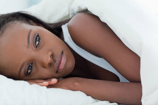 Lonely woman waking up in her bedroom