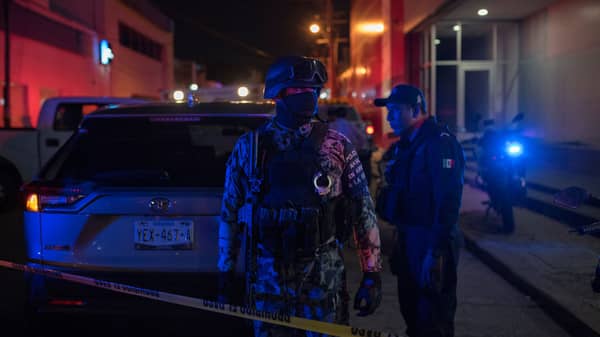 Federal forces keep watch at a crime scene following a deadly attack at a bar by unknown assailants in Coatzacoalcos