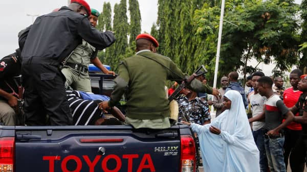 Police officers detain Shi’ite protesters in Abuja