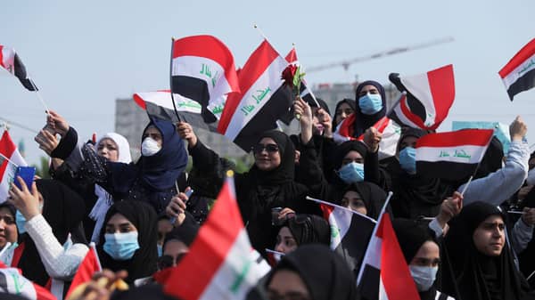 Universities students hold the Iraqi flag as they take part in a protest over corruption, lack of jobs, and poor services, in Kerbala