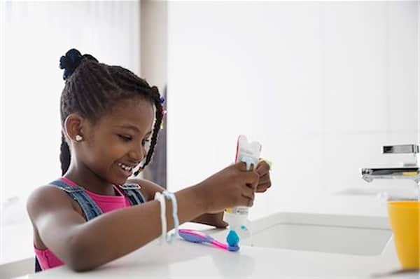 A child with a toothbrush and toothpaste