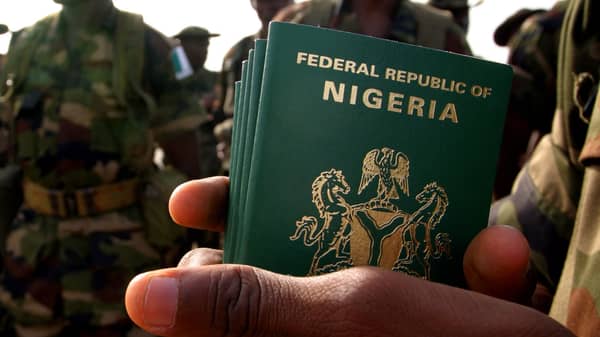 Nigerian officer holds passports for his troops about to board U.S. military plane to Darfur.
