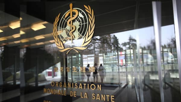 A logo is pictured outside a building of the WHO in Geneva