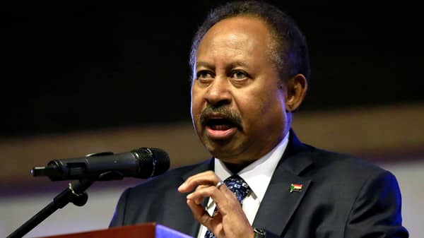 Sudan’s Prime Minister in the transitional government Abdalla Hamdok addresses people as they celebrate the first anniversary of the start of the uprising that toppled long-time ruler Omar al-Bashir, at the Friendship Hall in Khartoum