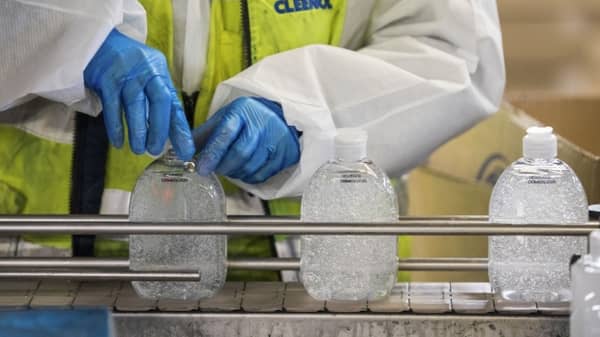 an-employee-screws-lids-on-