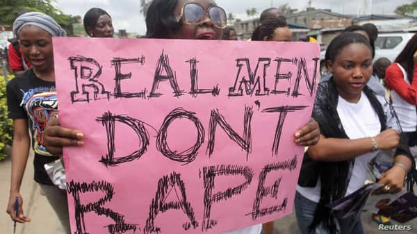 A woman carries a placard as she shouts a slogan during the “walk against rape'” procession organised by “Project Alert”, a Lagos-based NGO focusing on women’s issues, in Lagos