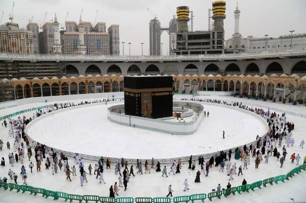 muslim_worshippers_circumambulate_the_sacred_kaaba_in_meccas_grand_mosque_islams_holiest_site_on_march_13_2020._afp