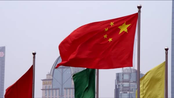 576799049-chinese-flag-blowing-waving-somebody-waving-a-flag-shanghai-city