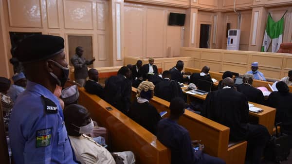 A police member stands guard as lawyers sit for an appeal hearing about a blasphemy conviction, in northern Nigeria’s Kano state