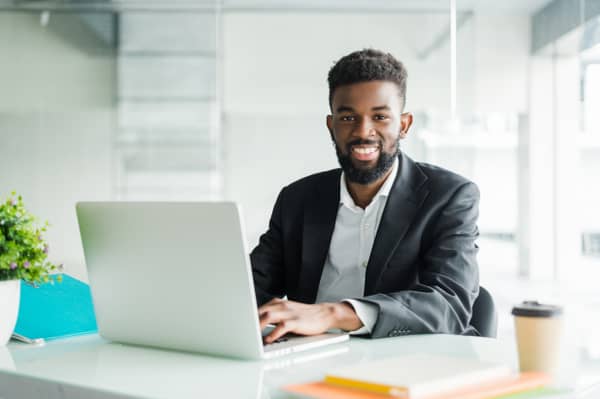 portrait-handsome-african-black-young-business-man-working-laptop-office-desk_231208-680
