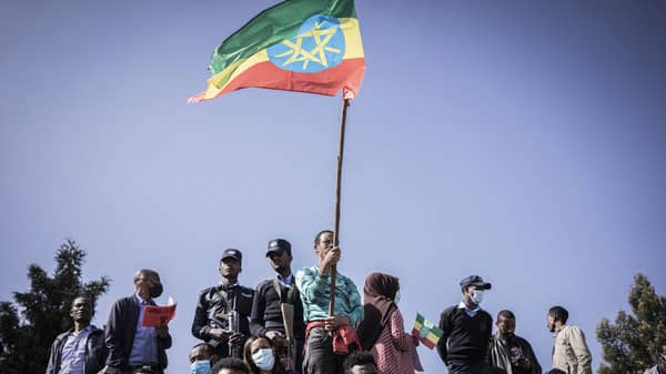 A man holds the Ethiopian national flag)