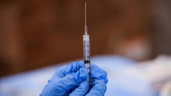 FILE PHOTO: A syringe is filled with a dose of Pfizer’s coronavirus disease (COVID-19) vaccine  at a pop-up community vaccination center in Valley Stream, New York