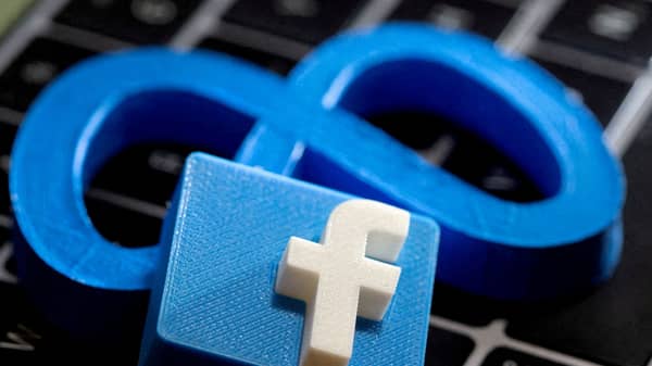 FILE PHOTO: 3D-printed images of the logos of Facebook and parent company Meta Platforms are seen on a laptop keyboard in this illustration