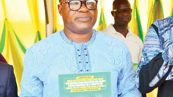 Adegoke-displaying-the-cocoa-handbook