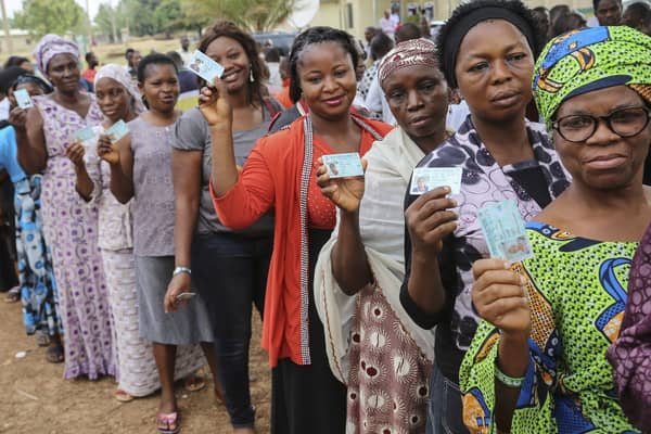 NIgerian-Voters-display-their-PVCs-prior-to-voting-election