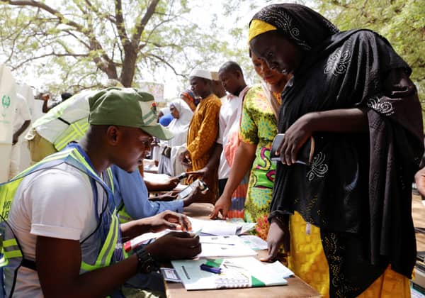 People arrive to cast their votes during Nigeria’s presidential election at a polling station in Yola
