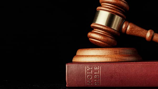 judge gavel with holy bible on black background