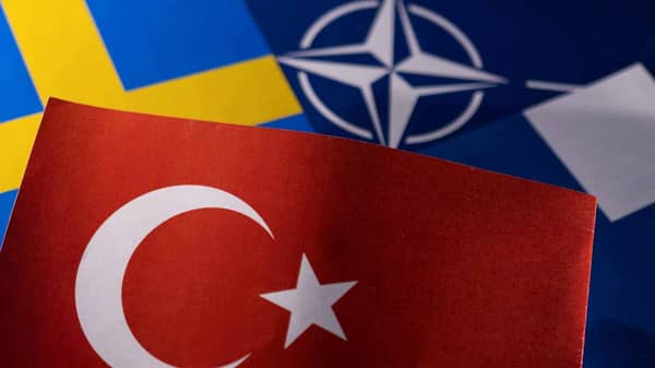 Illustration shows NATO, Turkish, Swedish and Finnish flags