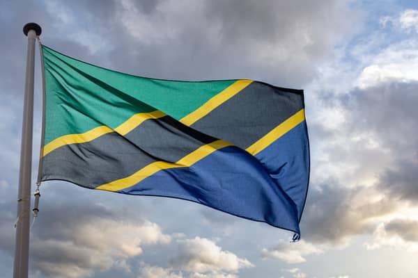 Tanzania flag waving against cloudy sky