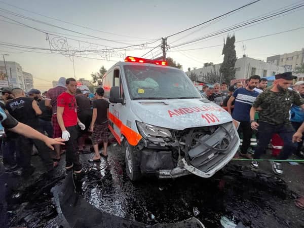 FILE PHOTO: Palestinians check the damages of an ambulance convoy