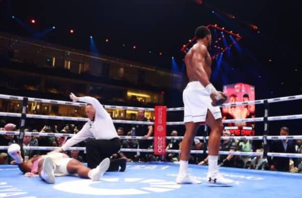 Francis Ngannou is knocked down for the third time as Referee Ricky Gonzalez checks on him during the Heavyweight fight between Anthony Joshua and Francis Ngannou on the Knockout Chaos boxing card at the Kingdom Arena on March 08, 2024 in Riyadh, Saudi Arabia. (Photo by Richard Pelham/Getty Images)