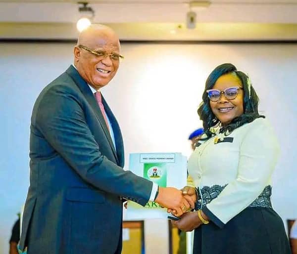 Akwa Ibom State Governor, Pastor Eno Umo, congratulating one of the new Permanent Secretaries, Mrs Grace Akpan.