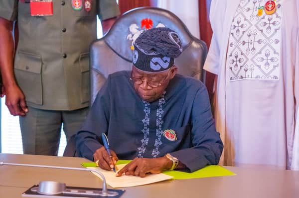 Tinubu signs-1