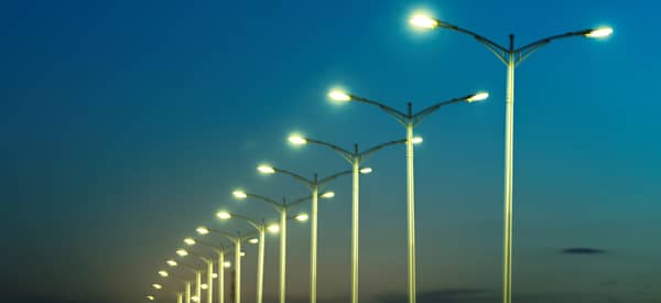 street lamps under blue sky at dusk