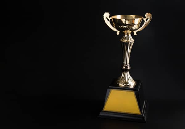 115310436-golden-trophy-over-black-background-winning-awards-with-copy-space-for-text-and-design