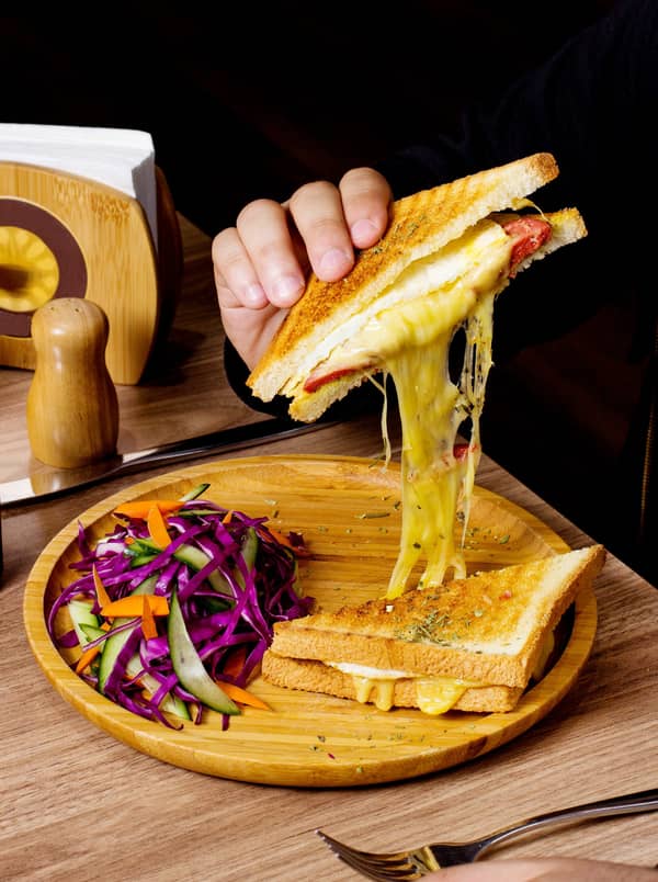 man-eats-sandwich-served-with-salad (1)