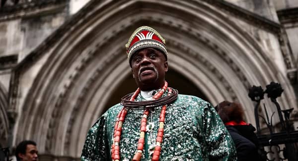 Nigerian tribal king Emere Godwin Bebe Okpabi stands outside the Royal Courts of Justice in London In February 2025 at the preliminary oil spill trial against Shell