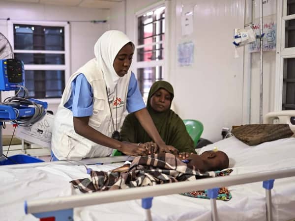 An MSF nurse examines Fatima Bukar’s four-year-old son, Mohammed, at an MSF facility in Maiduguri, Borno State, Nigeria.