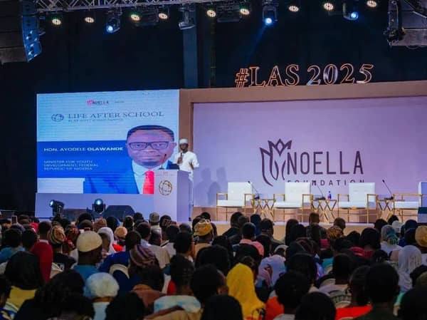 The image shows the Minister of Youth Development for the Federal Republic of Nigeria, Ayodele Olawande, speaking at the Life After School (LAS) 2025 summit.