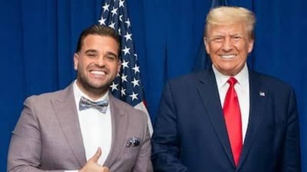 The image shows former U.S. President Donald Trump and Michigan businessman Mark Savaya. The photo was taken in relation to Trump’s recent appointment of Savaya as the U.S. special envoy to Iraq.
