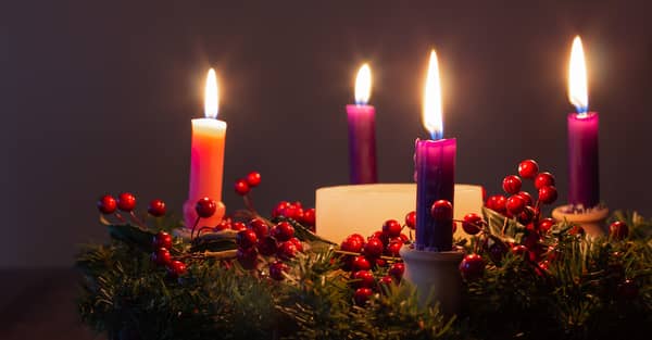 close up of Christmas advent wreath with candles lit
