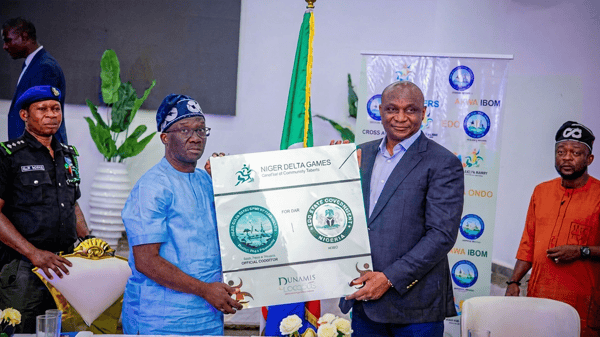 Edo State Governor, Monday Okpebholo (left), receiving the hosting right plaque from NDDC Managing Director, Dr Samuel Ogbuku, during the unveiling of Benin as host city for the 2026 Niger Delta Games on Tuesday.