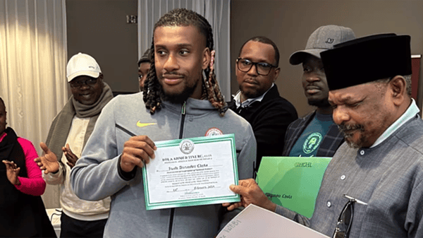 Super Eagles midfielder, Alex Iwobi displayes his land and house certicate