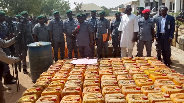 Customs officers with seized goods