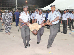 An agent to one of the NLC presidential candidates, who slumped during vote count at the NLC election, being assisted by the Police in Abuja... Saturday morning      //Photo LADIDI LUCY ELUKPO