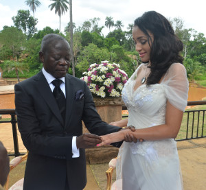 Governor Adams Oshiomole slips a ring on the finger of former Miss Iara Fortes at a private marriage registry at Iyamho, Etsako West Local Government Area of Edo State, on Friday