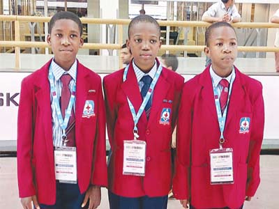 Pupils of Deeper Life High School Port Harcourt, Oluyoye Daniel (left); Nnaemeka Chukwuebuka and Ogbonna Chibuoyim at the World Robot Olympiad event in Qatar.